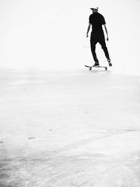 Rear view of man skating on skateboard park