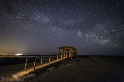 Scenic view of sea against star field at night