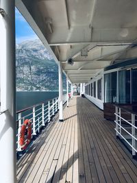 Walkway by sea seen through window