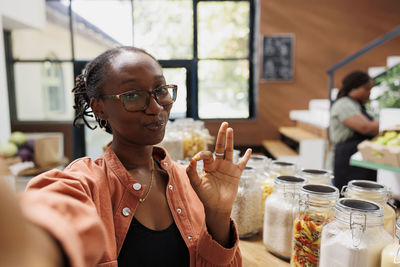 Portrait of young woman drinking glass