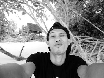 Portrait of young man against plants