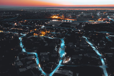 High angle view of illuminated city buildings at night