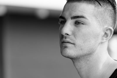 Close-up portrait of young man looking away