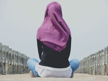 Midsection of man sitting outdoors