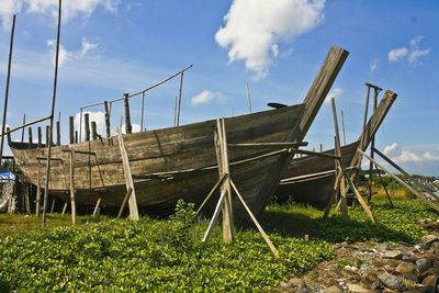 Boat on field against sky