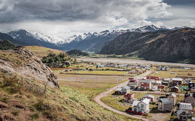 Scenic view of field and mountains against sky