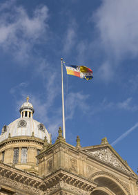 Low angle view of flags against sky