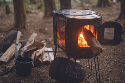 Winter camping. chopping wood with an axe and stoking the wood stove.