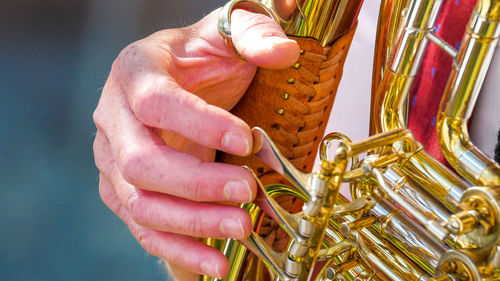 Cropped hand of man playing trumpet