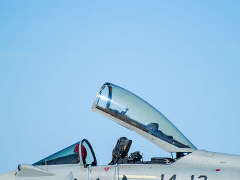 Low angle view of airplane against clear blue sky