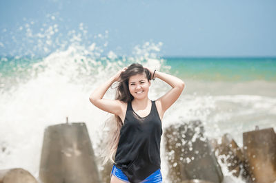 Portrait of mature man on beach against sky