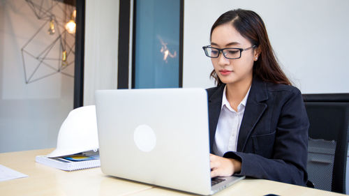 Businesswoman using laptop at office