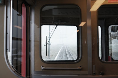 Close-up of train window during winter