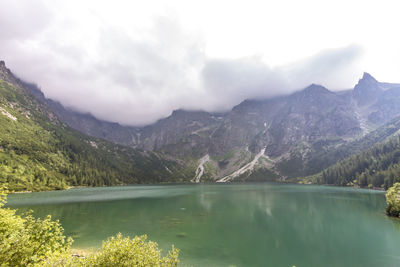 Scenic view of lake and mountains against sky