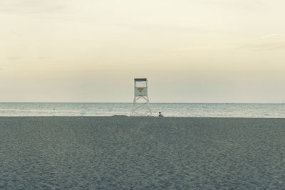 Lifeguard hut on beach against sky