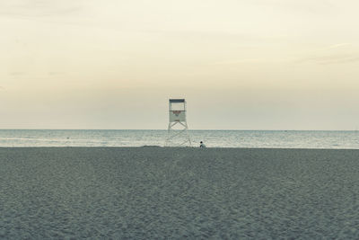 Lifeguard hut on beach against sky