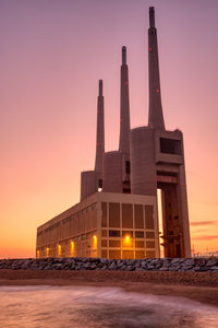 The disused thermal power station at sand adria near barcelona at sunset