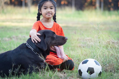 Boy with dog on field