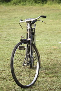 Close-up of bicycle on field