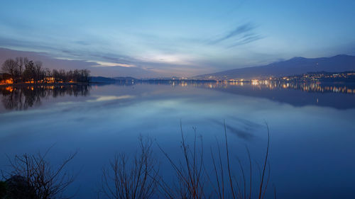 Scenic view of lake against sky at sunset