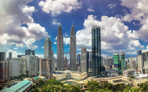 Cityscape against cloudy sky