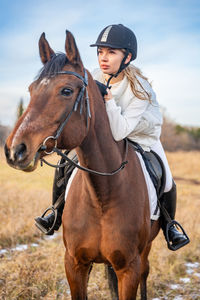 Portrait of horse standing on field