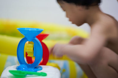 Side view of a boy holding toy