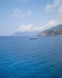 Sailboat sailing on sea against sky