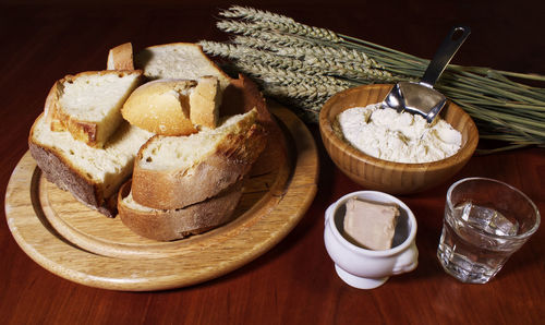 Ingredients of making bread on wooden table.