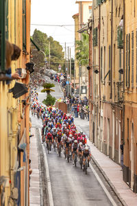 Cyclists compete during milano sanremo 2025 in via amendola, imperia, italy