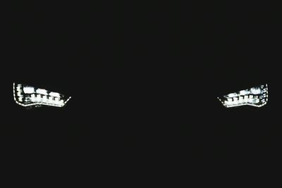 Low angle view of illuminated lights at night
