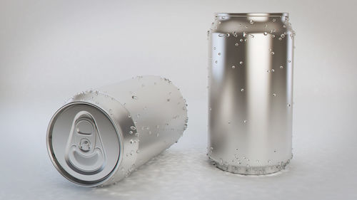 Close-up of water drops on bottle against white background