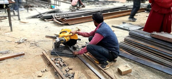 High angle view of man working on metal