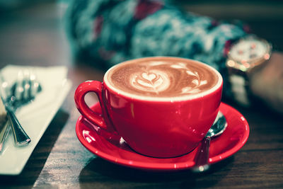 Close-up of cappuccino served on table