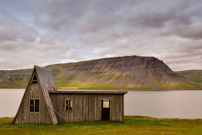 House on mountain against sky