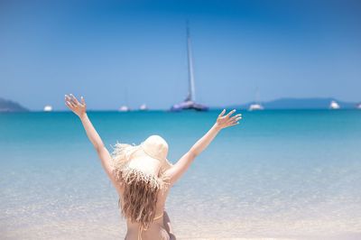 Rear view of man walking on beach