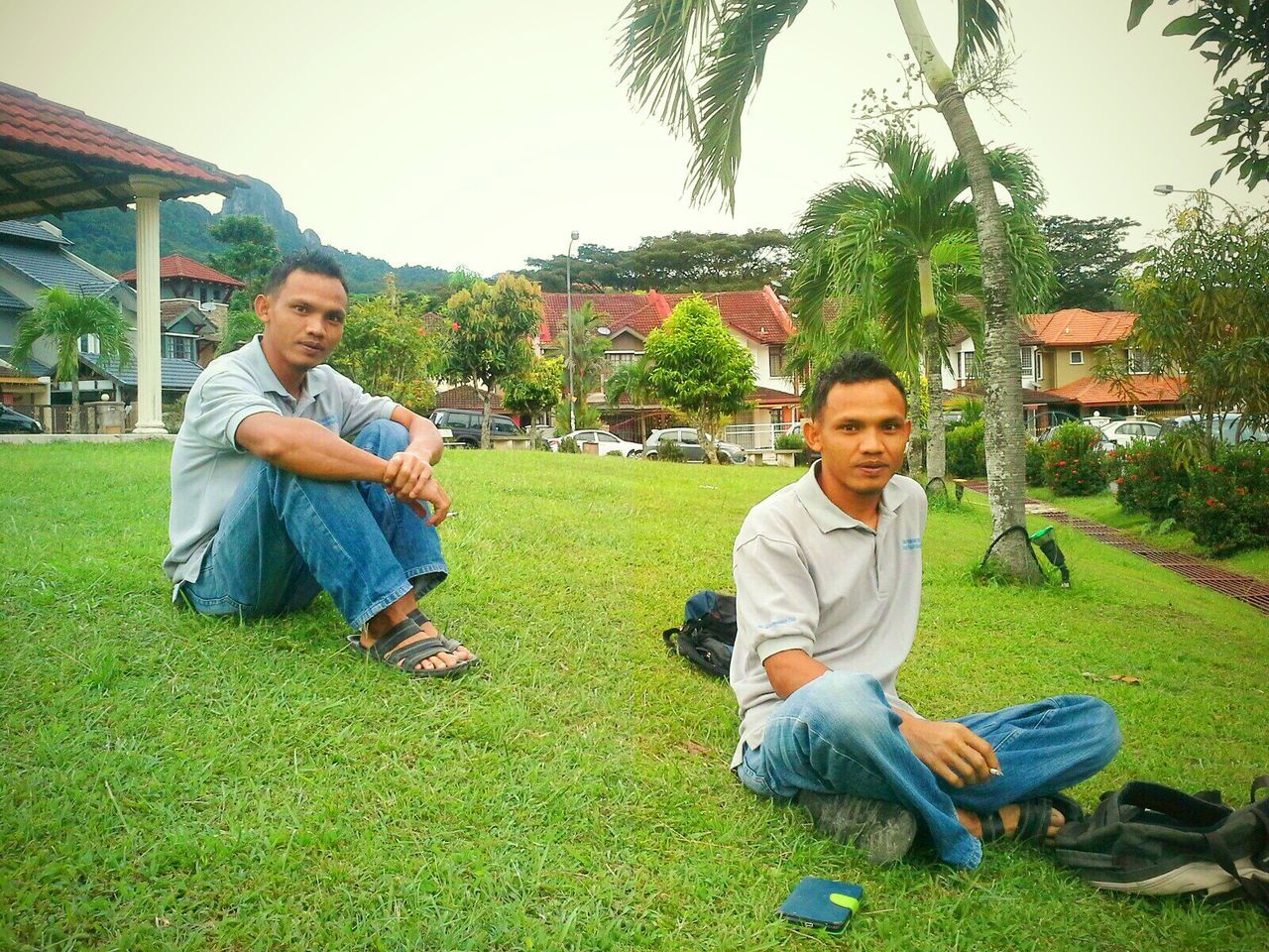 person, casual clothing, grass, lifestyles, leisure activity, young adult, smiling, togetherness, happiness, bonding, full length, young men, looking at camera, tree, portrait, childhood, green color