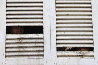 Boy looking through window