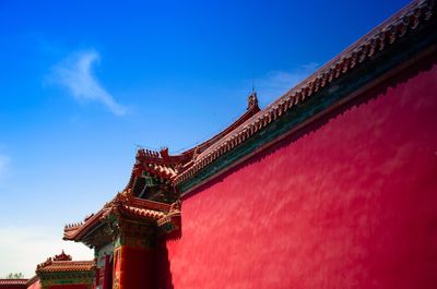 Low angle view of temple building against blue sky