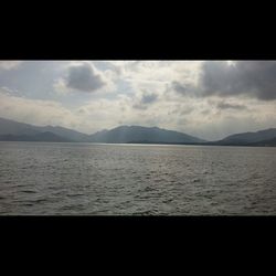 Scenic view of mountains against cloudy sky