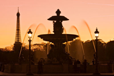 Statue of fountain against sky during sunset