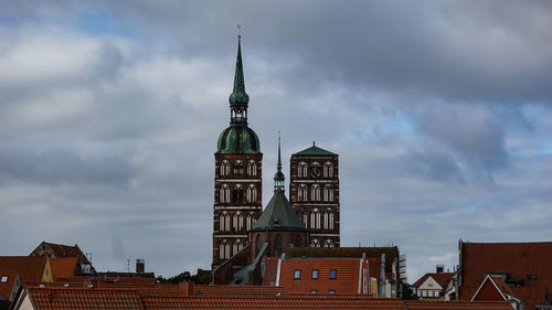 Low angle view of building against cloudy sky