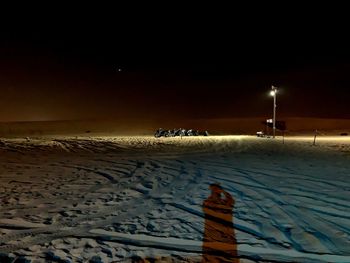 Scenic view of snow covered beach against sky at night
