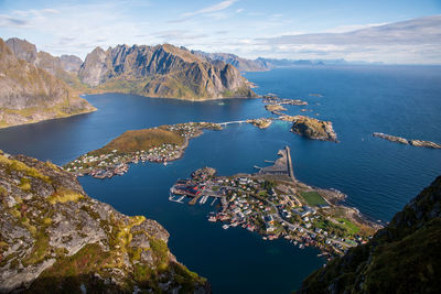 High angle view of sea and mountains against sky