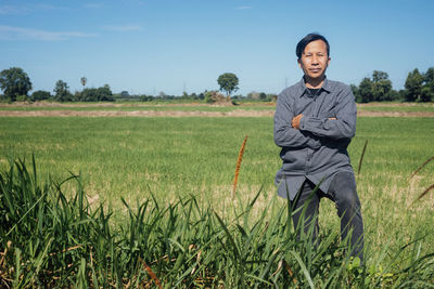 Portrait of man standing in field