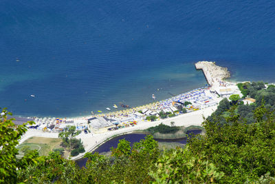 High angle view of buildings and sea in town