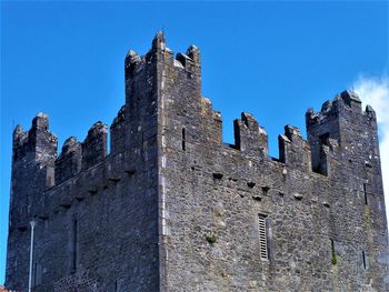 Low angle view of historic building against clear blue sky