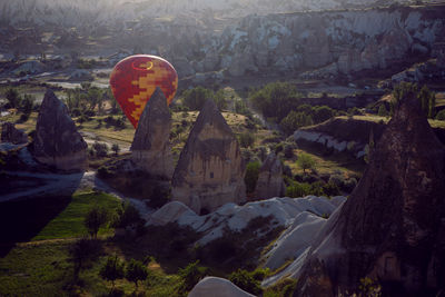 Large red orange balloon landed on the ground and is ready to be assembled in cappadocia in turkey