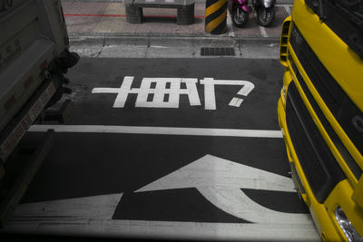 High angle view of arrow sign on road in city