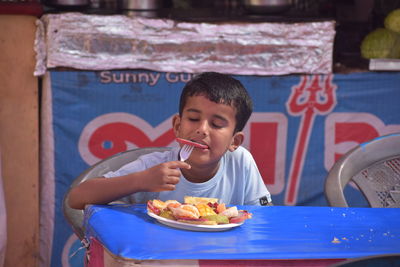 Boy eating fruits salad healthy diet 